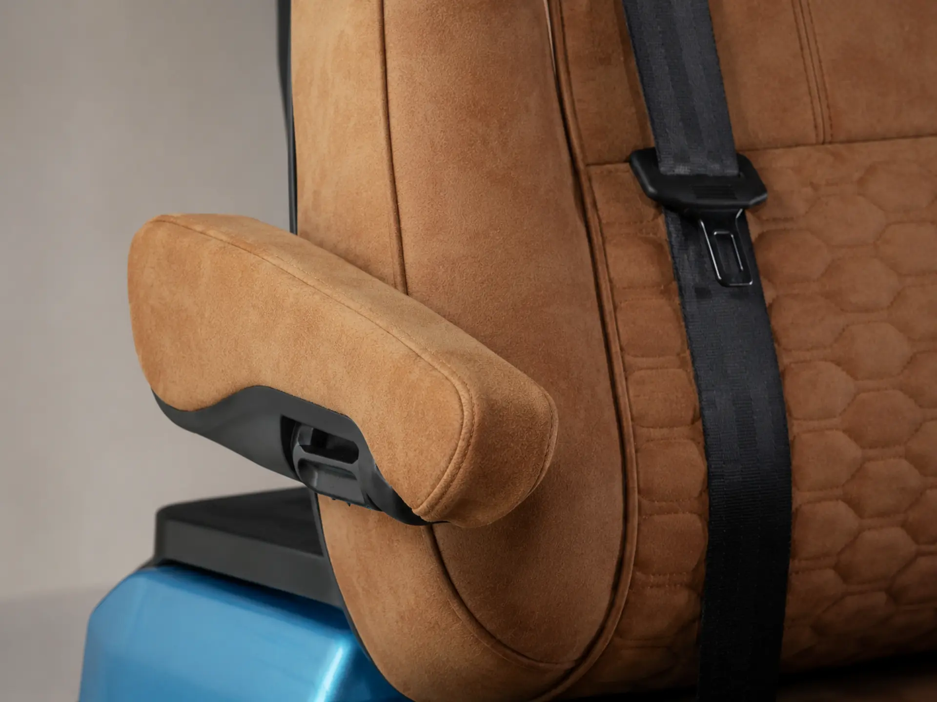 Tan leather armrest and seatbelt detail