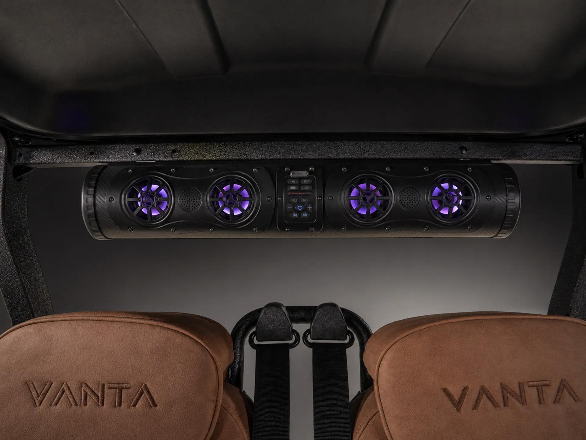 Overhead audio bar with purple-lit speakers and embossed Vanta leather headrests