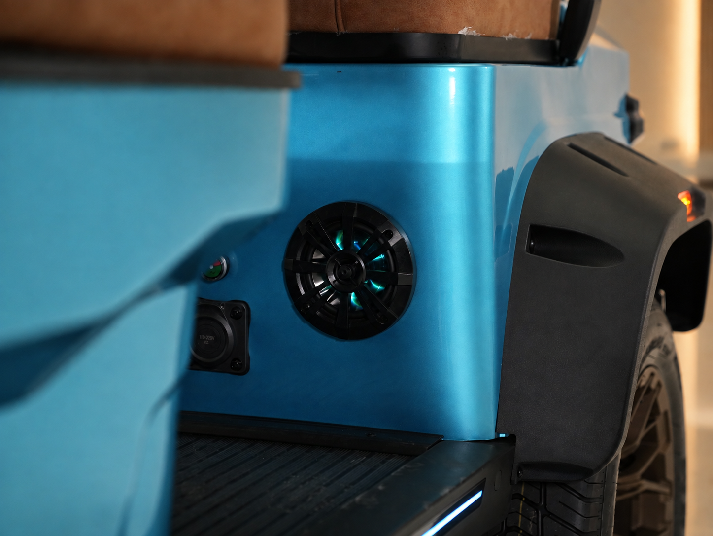 Side-mounted speaker on a blue Vanta body with charging port