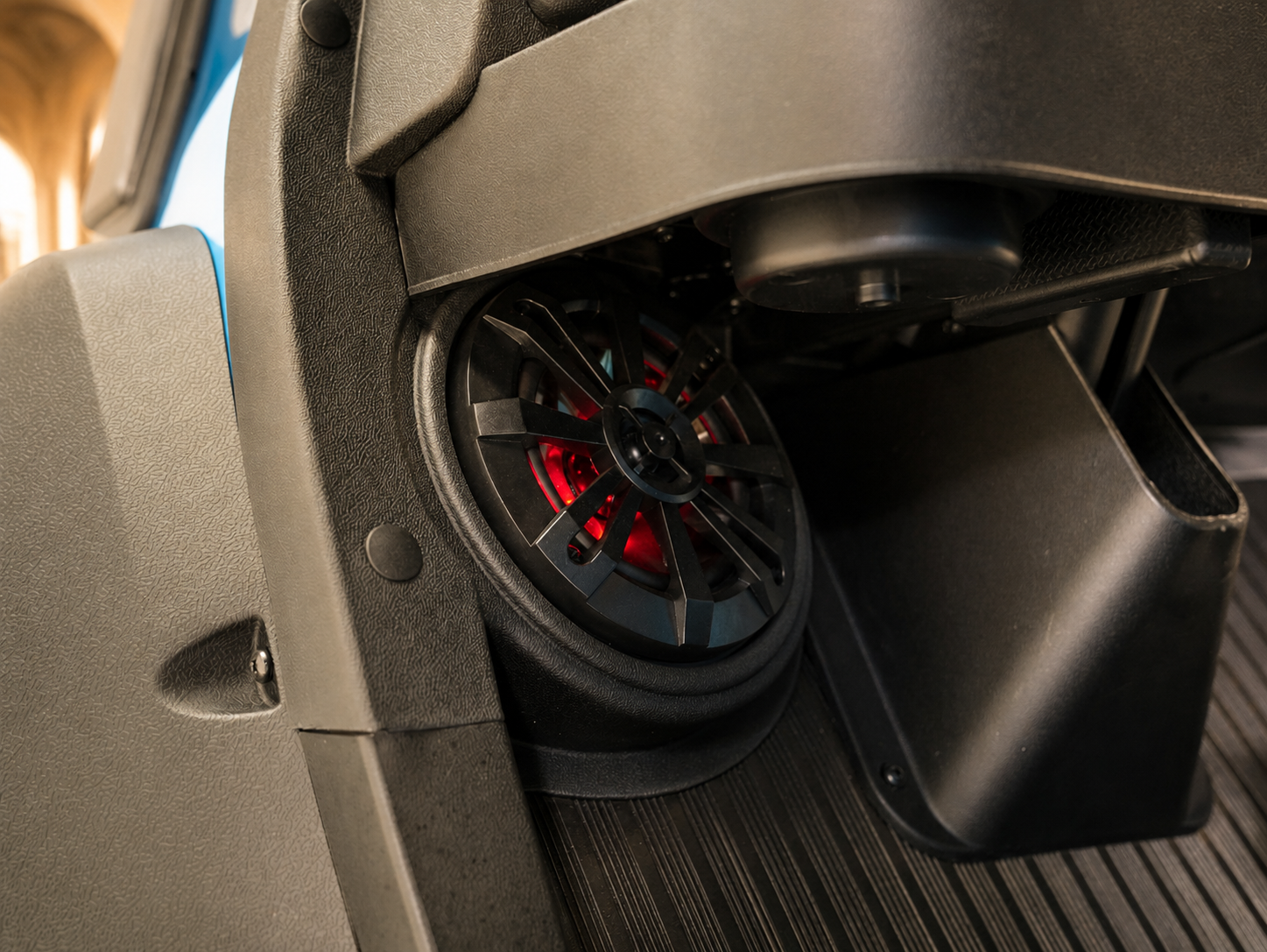 Close-up speaker woofer with red ambient lighting